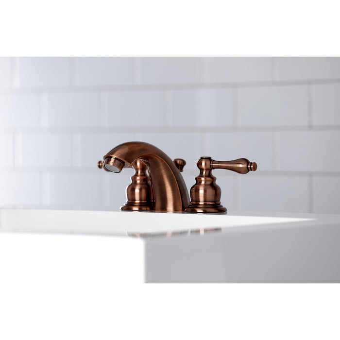 Kingston Heirloom KB946AL - Victorian Two-Handle 3-Hole Deck Mount Mini-Widespread Bathroom Faucet with Pop-Up Drain, Antique Copper