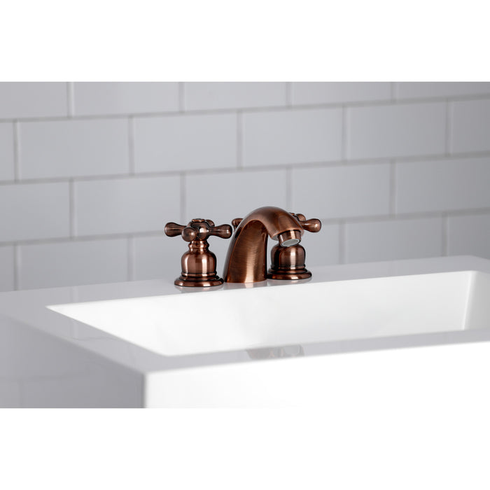 Kingston Heirloom KB946AX - Victorian Two-Handle 3-Hole Deck Mount Mini-Widespread Bathroom Faucet with Pop-Up Drain, Antique Copper