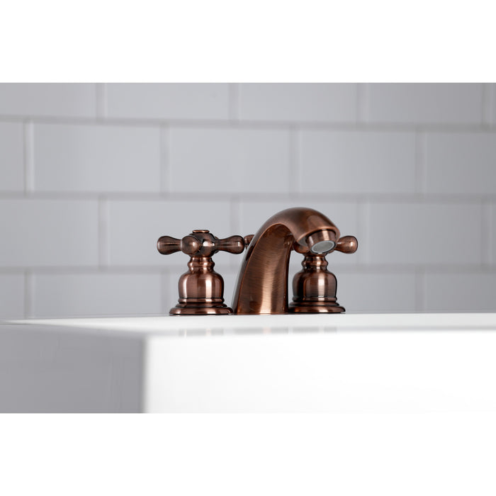 Kingston Heirloom KB946AX - Victorian Two-Handle 3-Hole Deck Mount Mini-Widespread Bathroom Faucet with Pop-Up Drain, Antique Copper
