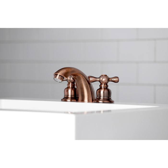 Kingston Heirloom KB946AX - Victorian Two-Handle 3-Hole Deck Mount Mini-Widespread Bathroom Faucet with Pop-Up Drain, Antique Copper