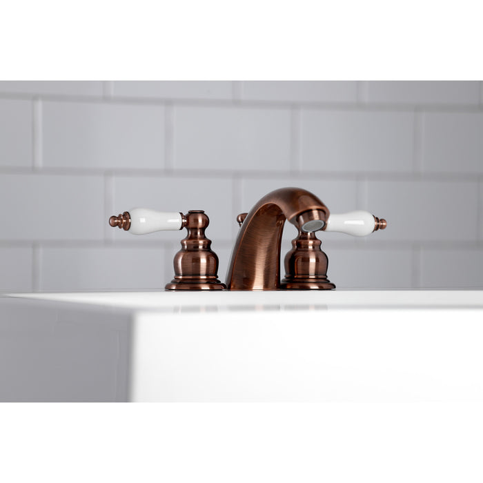 Kingston Heirloom KB956PL - Victorian Two-Handle 3-Hole Deck Mount Mini-Widespread Bathroom Faucet with Pop-Up Drain, Antique Copper