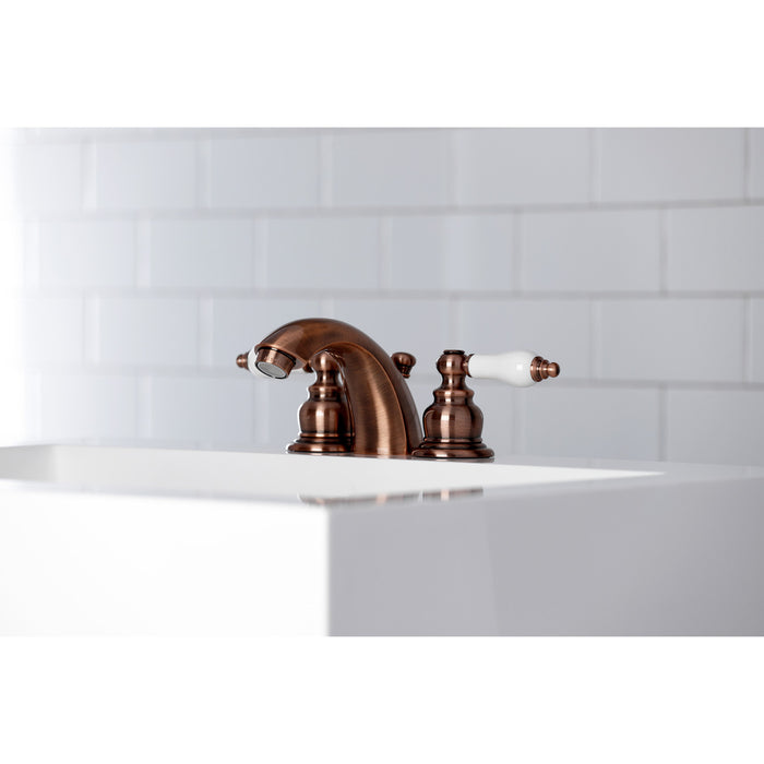 Kingston Heirloom KB956PL - Victorian Two-Handle 3-Hole Deck Mount Mini-Widespread Bathroom Faucet with Pop-Up Drain, Antique Copper