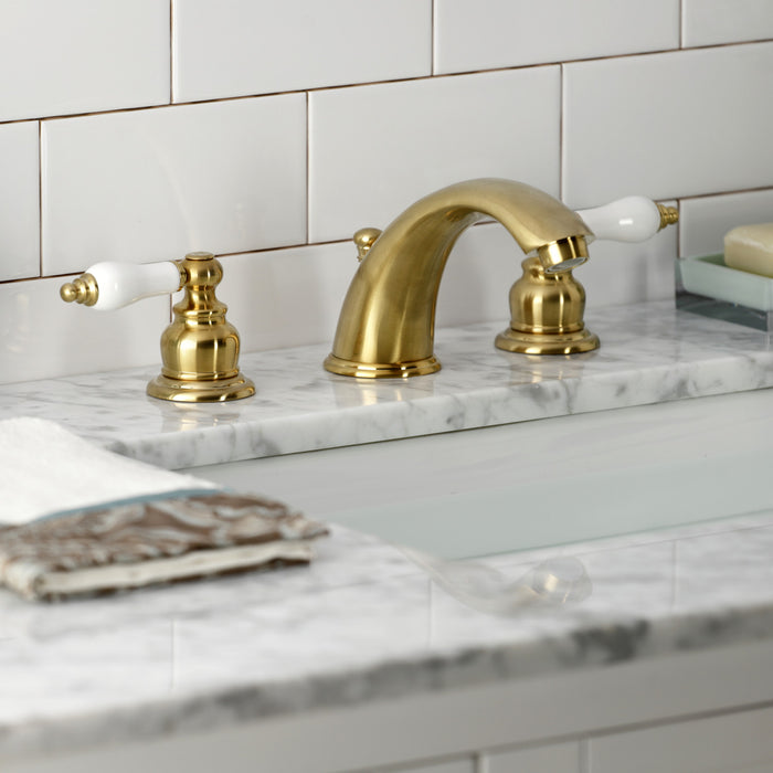 Kingston Heirloom KB977B - Victorian Two-Handle 3-Hole Deck Mount Widespread Bathroom Faucet with Pop-Up Drain, Brushed Brass