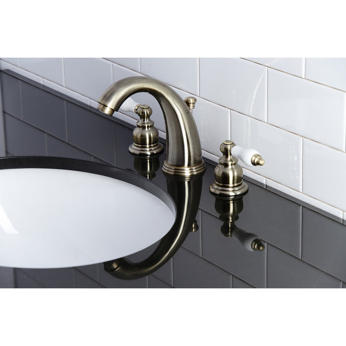 Kingston Heirloom KB983PLAB - Victorian Two-Handle 3-Hole Deck Mount Widespread Bathroom Faucet with Pop-Up Drain, Antique Brass