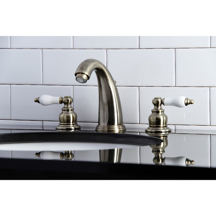 Kingston Heirloom KB983PLAB - Victorian Two-Handle 3-Hole Deck Mount Widespread Bathroom Faucet with Pop-Up Drain, Antique Brass