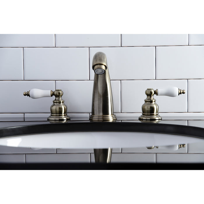Kingston Heirloom KB983PLAB - Victorian Two-Handle 3-Hole Deck Mount Widespread Bathroom Faucet with Pop-Up Drain, Antique Brass