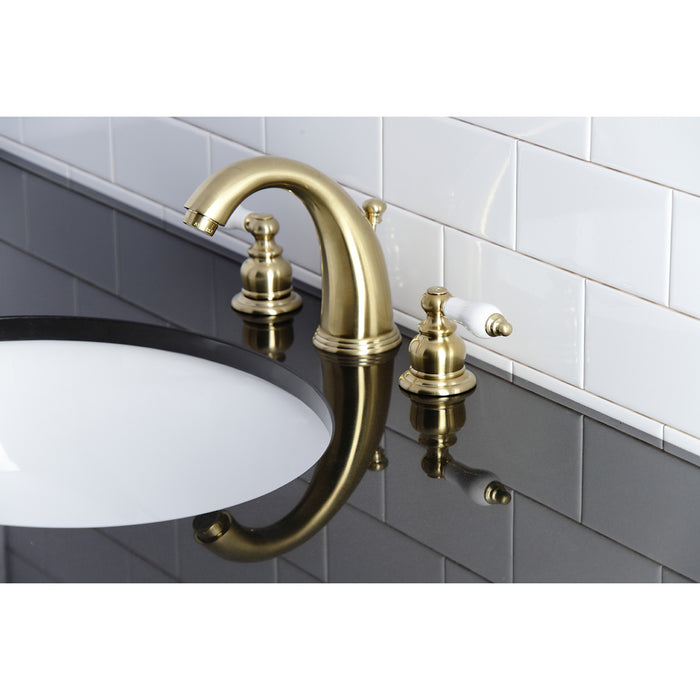 Kingston Heirloom KB987PLSB - Victorian Two-Handle 3-Hole Deck Mount Widespread Bathroom Faucet with Pop-Up Drain, Brushed Brass