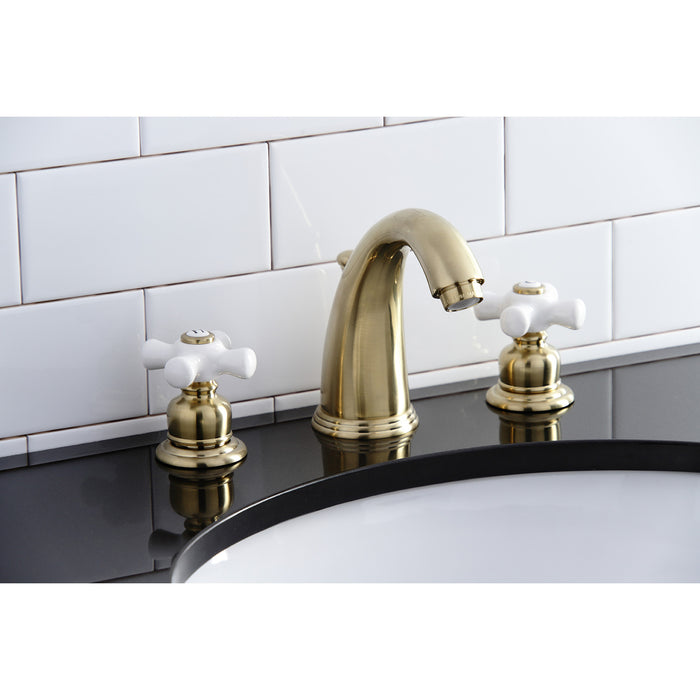 Kingston Heirloom KB987PXSB - Victorian Two-Handle 3-Hole Deck Mount Widespread Bathroom Faucet with Pop-Up Drain, Brushed Brass