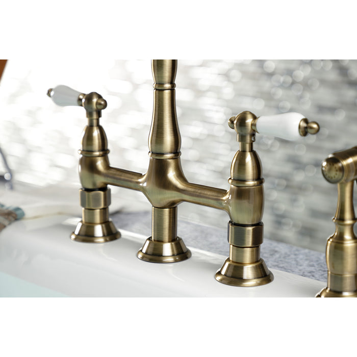 Kingston Heirloom KS1273PLBS - Heritage Two-Handle 4-Hole Deck Mount Bridge Kitchen Faucet with Brass Sprayer, Antique Brass