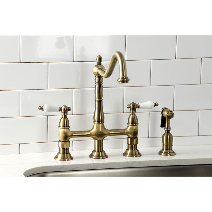 Kingston Heirloom KS1273PLBS - Heritage Two-Handle 4-Hole Deck Mount Bridge Kitchen Faucet with Brass Sprayer, Antique Brass