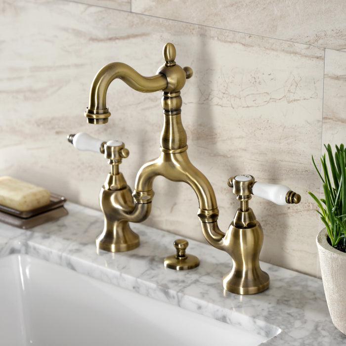 Kingston Heirloom KS7973BPL - Bel-Air Two-Handle 3-Hole Deck Mount Bridge Bathroom Faucet with Brass Pop-Up, Antique Brass