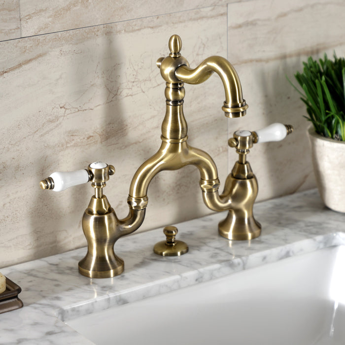 Kingston Heirloom KS7973BPL - Bel-Air Two-Handle 3-Hole Deck Mount Bridge Bathroom Faucet with Brass Pop-Up, Antique Brass