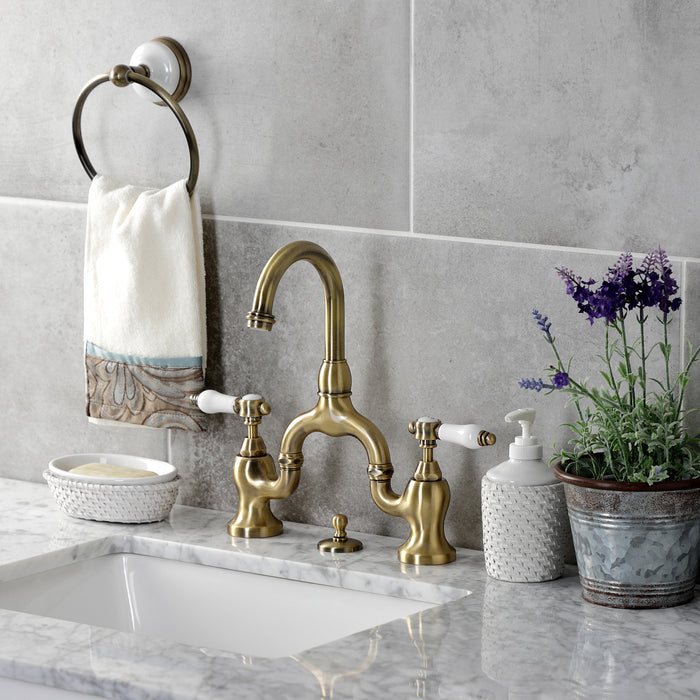 Kingston Heirloom KS7993BPL - Bel-Air Two-Handle 3-Hole Deck Mount Bridge Bathroom Faucet with Brass Pop-Up, Antique Brass