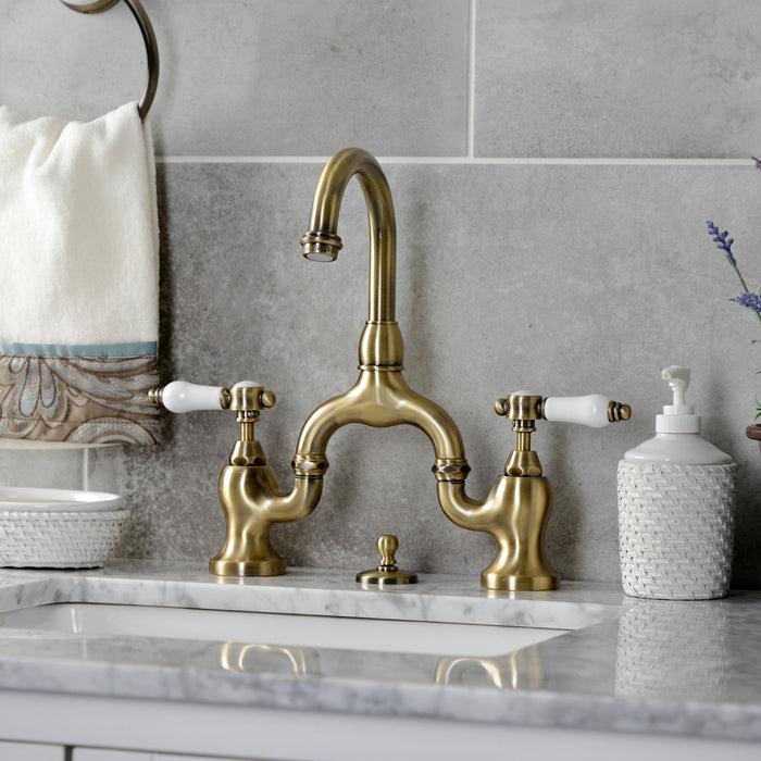 Kingston Heirloom KS7993BPL - Bel-Air Two-Handle 3-Hole Deck Mount Bridge Bathroom Faucet with Brass Pop-Up, Antique Brass
