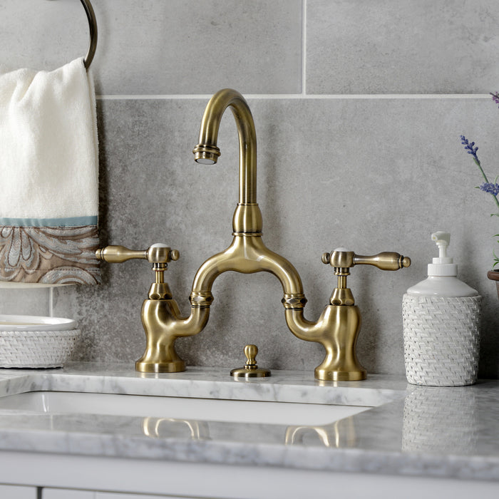 Kingston Heirloom KS7993TAL - Tudor Two-Handle 3-Hole Deck Mount Bridge Bathroom Faucet with Brass Pop-Up, Antique Brass