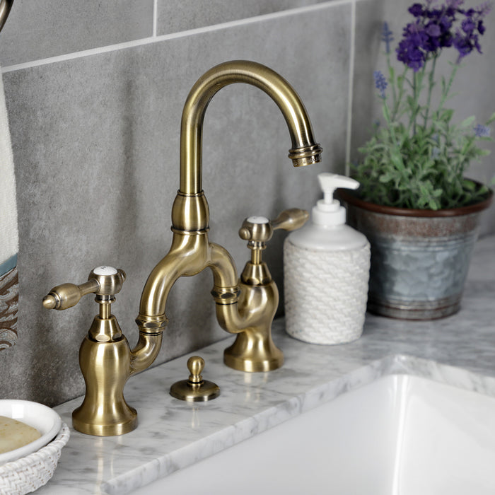Kingston Heirloom KS7993TAL - Tudor Two-Handle 3-Hole Deck Mount Bridge Bathroom Faucet with Brass Pop-Up, Antique Brass