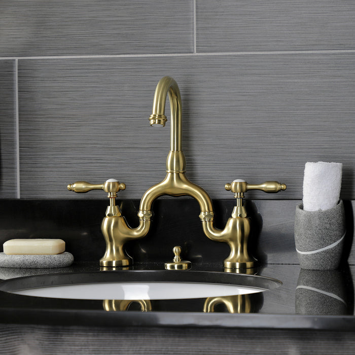 Kingston Heirloom KS7997TAL - Tudor Two-Handle 3-Hole Deck Mount Bridge Bathroom Faucet with Brass Pop-Up, Brushed Brass