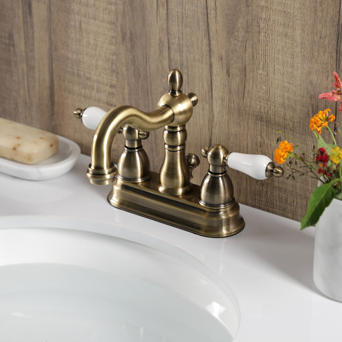 Heritage KB1603PL Two-Handle 3-Hole Deck Mount 4" Centerset Bathroom Faucet with Plastic Pop-Up, Antique Brass