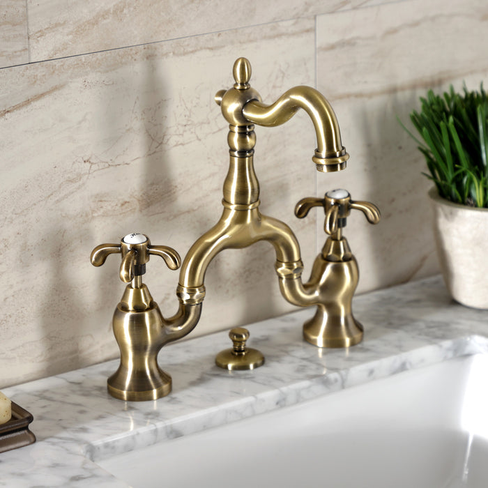 Kingston Heirloom KS7973TX - French Country Two-Handle 3-Hole Deck Mount Bridge Bathroom Faucet with Brass Pop-Up, Antique Brass